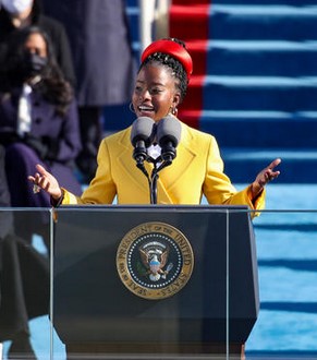 Amanda Gorman, youngest Poet Laureate. Yellow jacket, broad red band in hair.