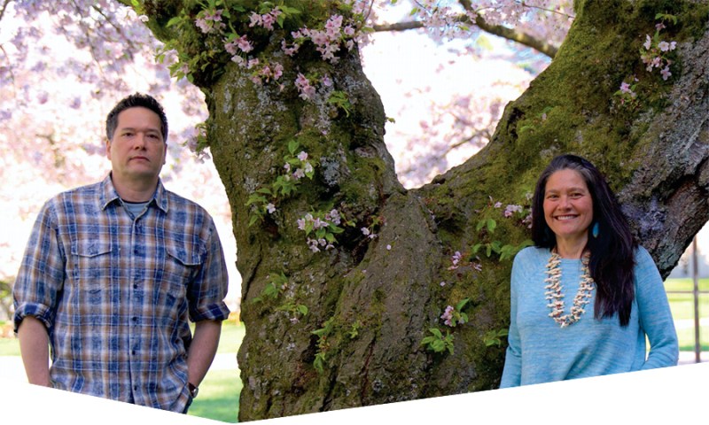 Brother-and-sister team Keith and Chenoa Egawa. A flowering tree as background.
