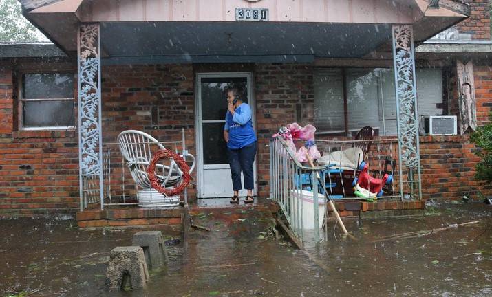 A woman on cellphone calls for help at her flooded residence in Lumberton, North Carolina, on Sept. 15, 2018 in the wake of Hurricane Florence.