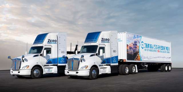 Two white and blue big-rigs.