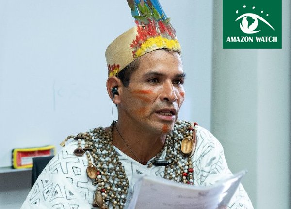 Man in feathered cap in Press Conference.