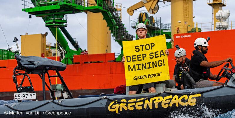 Greenpeace Boat with sign: Stop Deep Sea Mining.