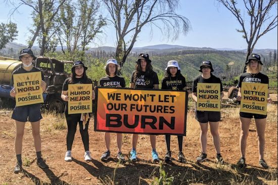 Generation On Fire Weekend. Seven youths in shorts holding sign, We won't let our Futures Burn.