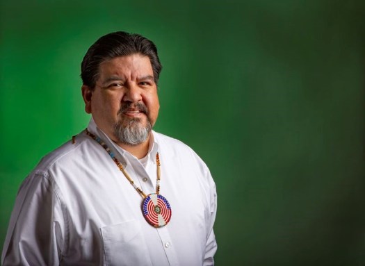 Photo of Chuck Sams in white shirt.