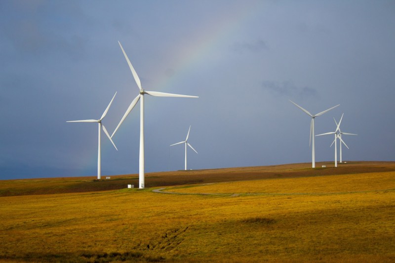 Windmills with rainbow in background.