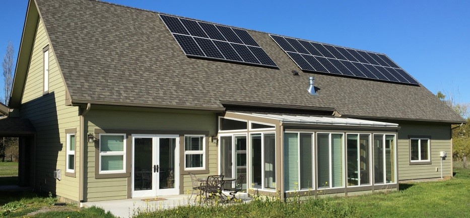 Home of David Large, featuring solar panels, passive solar design, and a solarium.
