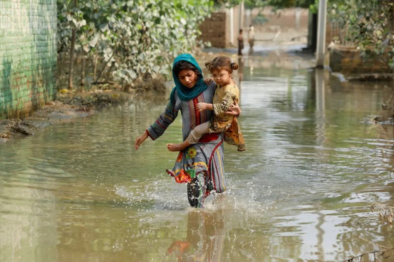Woman and girl in Pakistan flood. Photograph: Fayaz Aziz/Reuters