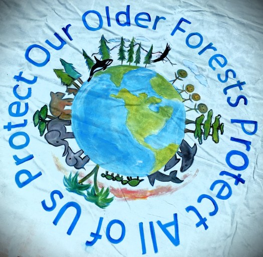 Banner with planet, trees, animals, people, saying "Protect Our Older Forests Protect All of Us" in a circle